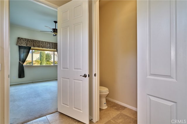 bathroom with ceiling fan and toilet