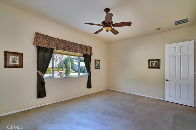 unfurnished room featuring ceiling fan and carpet