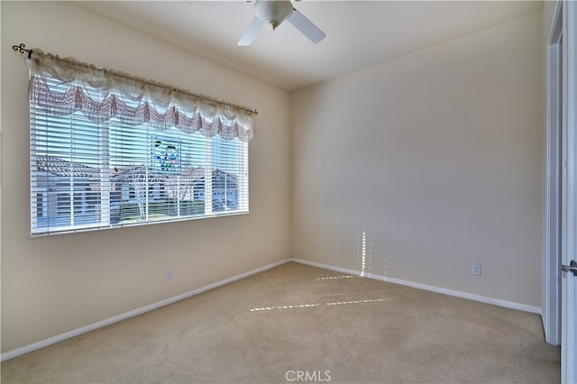 carpeted empty room featuring ceiling fan