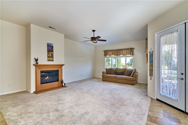 unfurnished living room featuring light colored carpet and ceiling fan