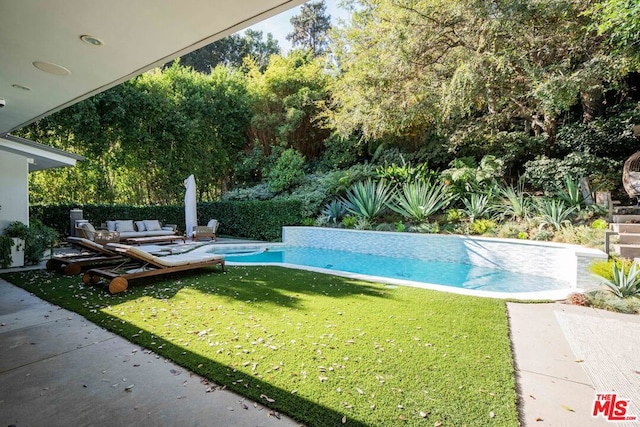 view of swimming pool featuring a lawn