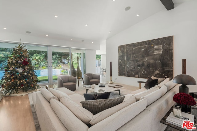 living room featuring vaulted ceiling and light hardwood / wood-style flooring