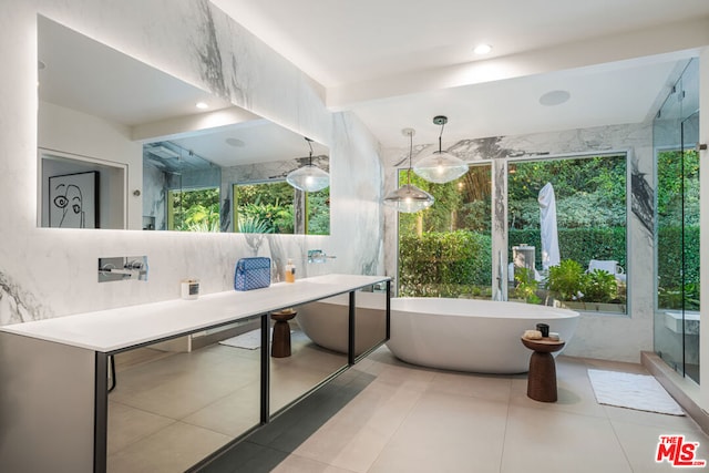 bathroom with a wealth of natural light, tile patterned floors, and beamed ceiling