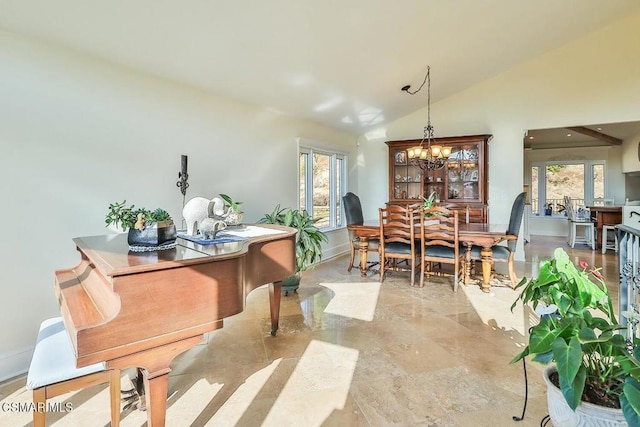 dining space featuring vaulted ceiling and a notable chandelier