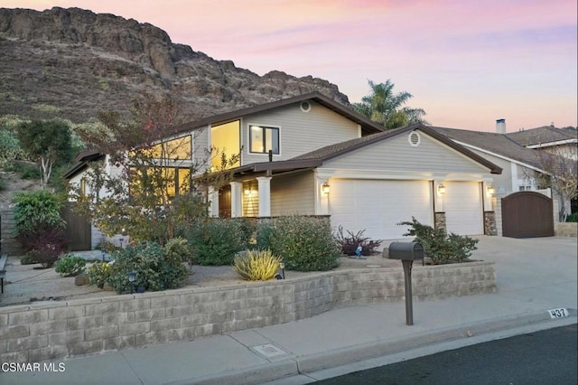 view of front of home with a mountain view and a garage