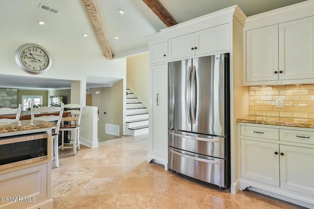 kitchen featuring white cabinetry, stone counters, stainless steel appliances, tasteful backsplash, and beam ceiling