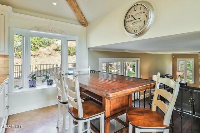 tiled dining area with vaulted ceiling with beams