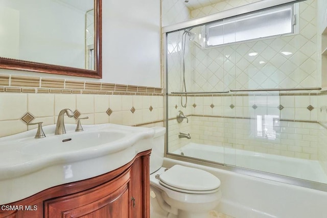 full bathroom with toilet, vanity, tile walls, decorative backsplash, and enclosed tub / shower combo