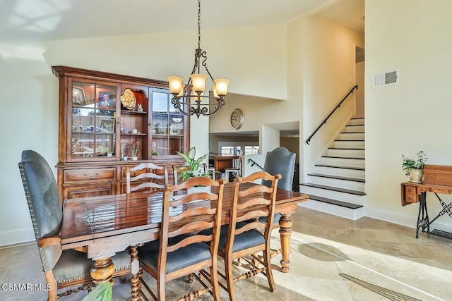 dining room featuring an inviting chandelier and lofted ceiling