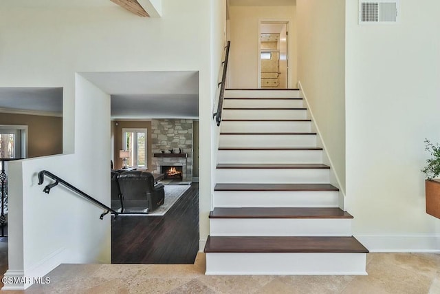 stairs with a stone fireplace