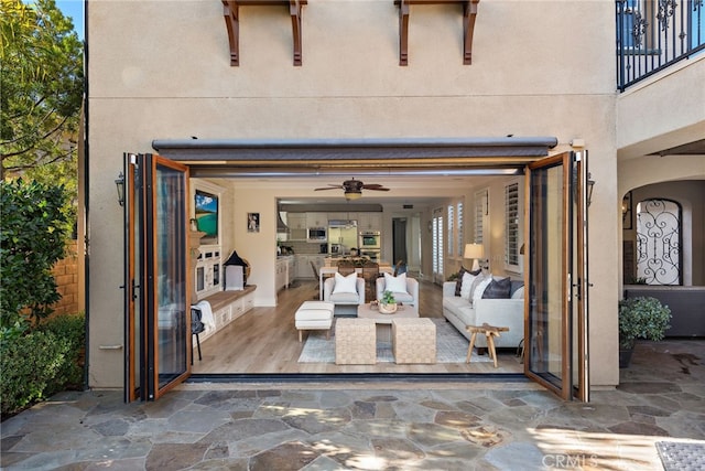 view of patio featuring ceiling fan and outdoor lounge area