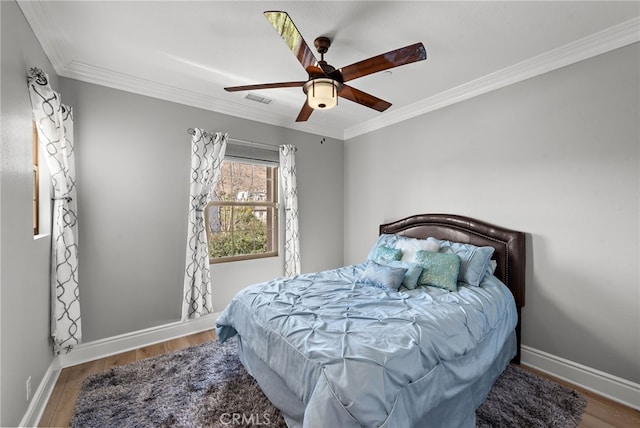 bedroom featuring ceiling fan, crown molding, and hardwood / wood-style flooring