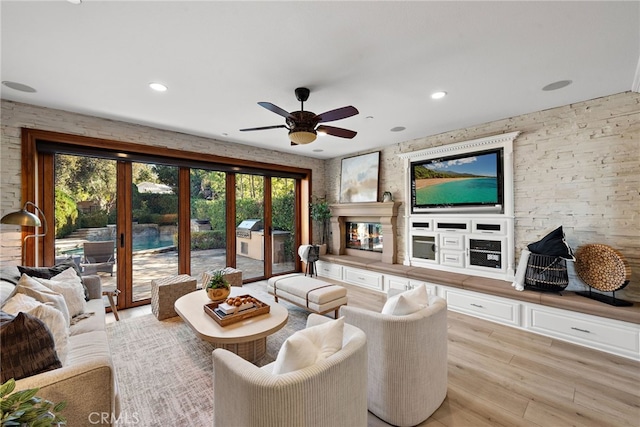 living room with ceiling fan, french doors, and light hardwood / wood-style floors