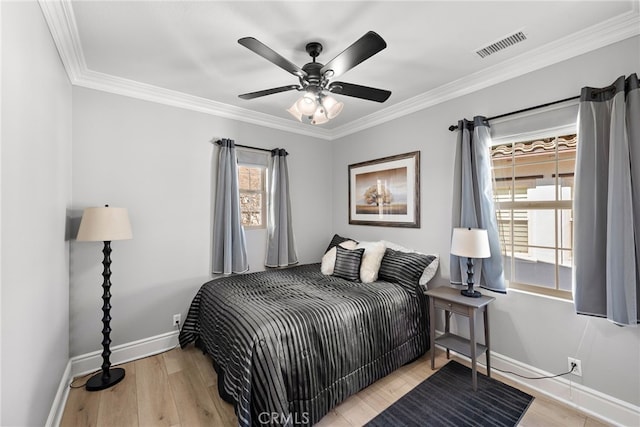 bedroom featuring ceiling fan, light hardwood / wood-style flooring, and crown molding