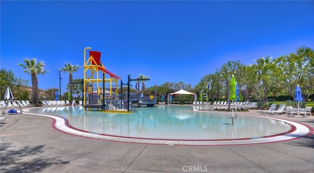 view of pool with a playground