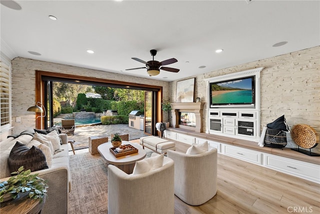 living room featuring light hardwood / wood-style floors and ceiling fan