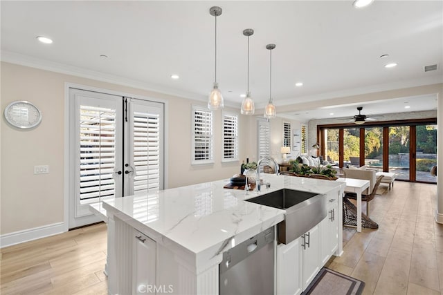 kitchen featuring sink, pendant lighting, dishwasher, and french doors