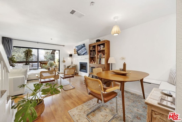 dining space with light hardwood / wood-style floors