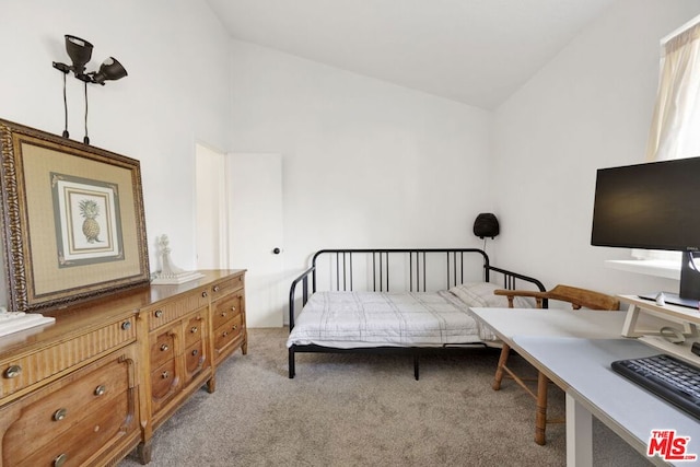 carpeted bedroom with lofted ceiling