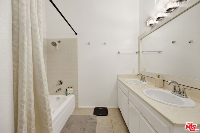 bathroom featuring shower / bath combo with shower curtain, tile patterned floors, and vanity