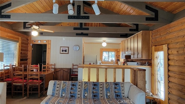 kitchen with white fridge, ceiling fan, wooden ceiling, rustic walls, and beamed ceiling