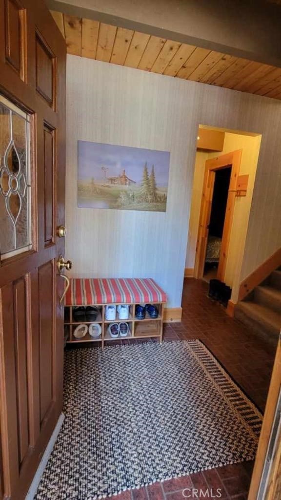 mudroom with wooden ceiling and baseboards