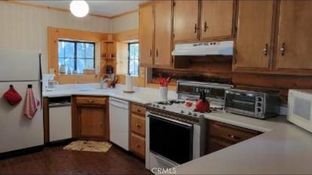 kitchen featuring white appliances, a toaster, ventilation hood, and light countertops