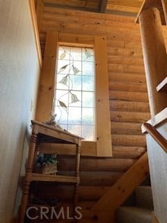 doorway to outside featuring rustic walls