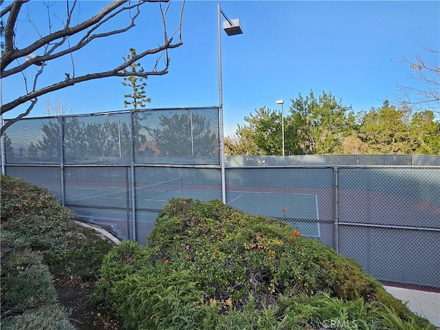 view of tennis court with fence