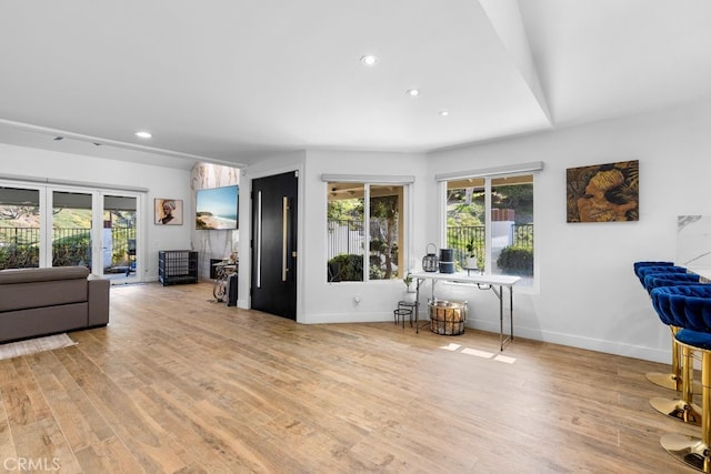 interior space featuring light wood-style flooring, baseboards, and recessed lighting