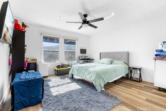 bedroom featuring light wood finished floors, recessed lighting, a ceiling fan, and baseboards