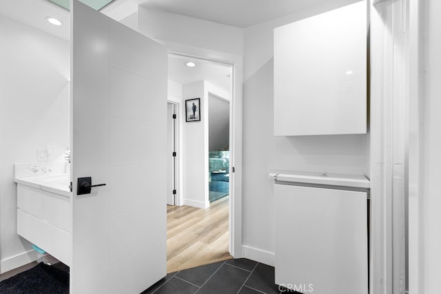 bathroom with recessed lighting, tile patterned flooring, baseboards, and vanity