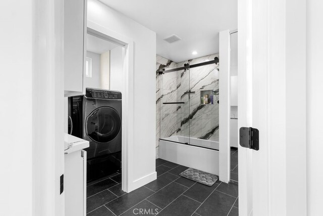 full bathroom featuring bath / shower combo with glass door, visible vents, washer and clothes dryer, and tile patterned floors