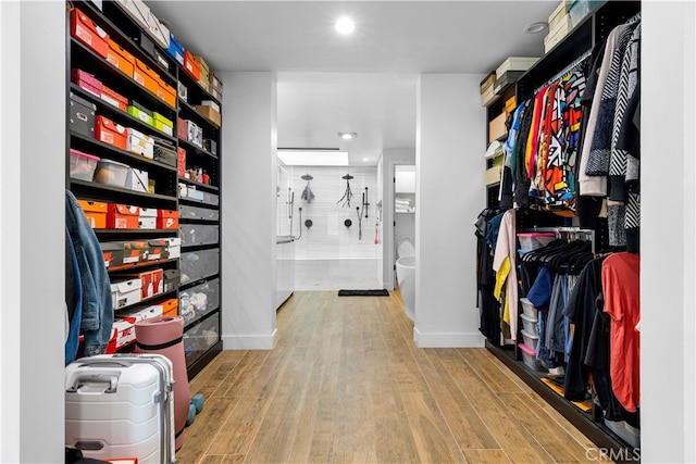 spacious closet featuring light wood-style flooring