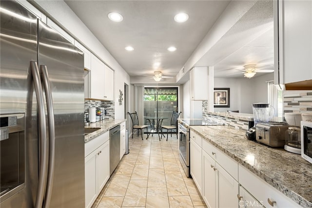 kitchen featuring decorative backsplash, white cabinetry, and stainless steel appliances