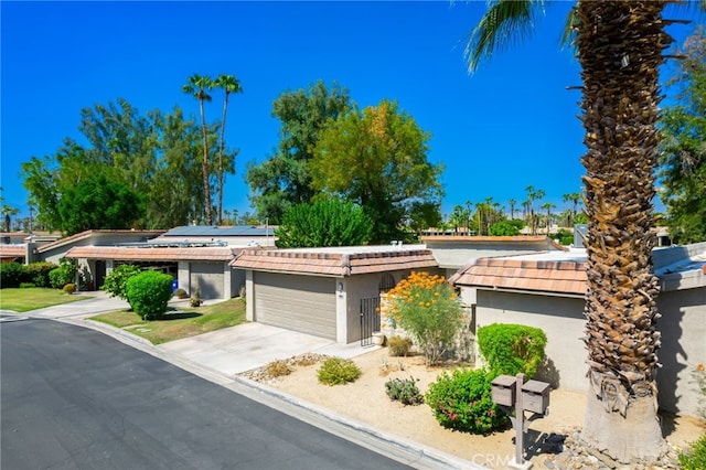 ranch-style home featuring solar panels and a garage