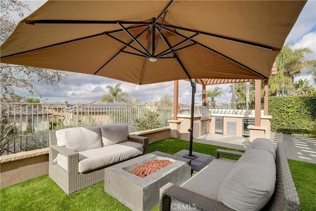 view of patio / terrace featuring area for grilling and an outdoor fire pit