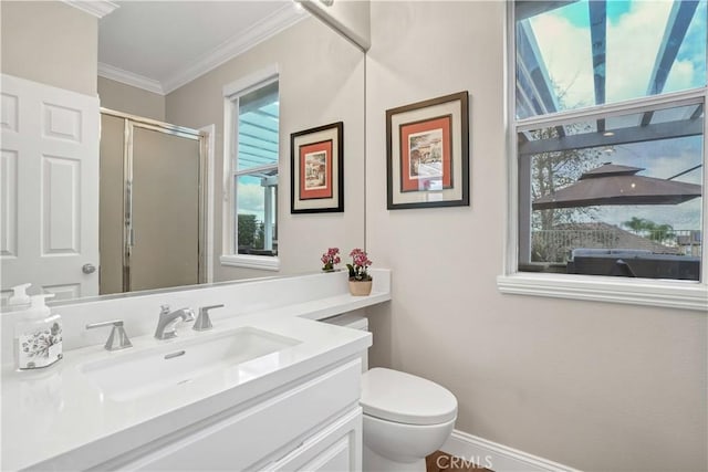 bathroom with ornamental molding, toilet, vanity, and a shower with shower door