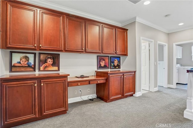 home office featuring crown molding, built in desk, light colored carpet, and independent washer and dryer