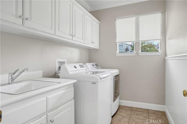 laundry area featuring separate washer and dryer, sink, cabinets, light tile patterned floors, and crown molding