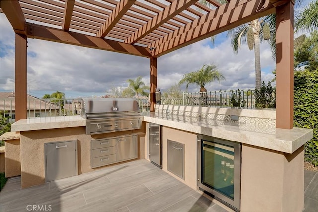 view of patio / terrace with an outdoor kitchen, wine cooler, grilling area, and a pergola