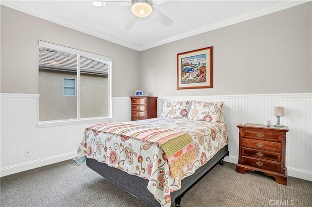 carpeted bedroom featuring ceiling fan and ornamental molding