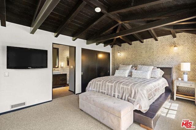 carpeted bedroom with wood ceiling, ensuite bath, and lofted ceiling with beams