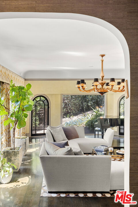 living room featuring wood-type flooring and a chandelier