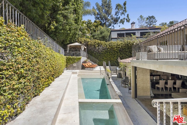 view of pool featuring a patio