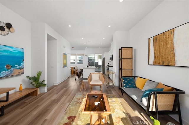 living room with sink and light wood-type flooring