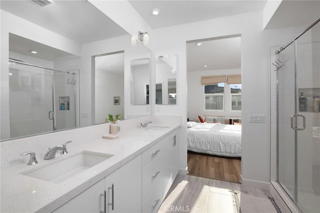 bathroom with vanity, wood-type flooring, and an enclosed shower