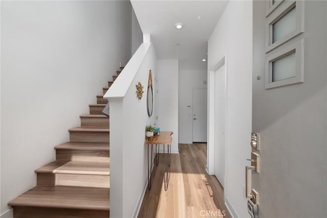 stairs with hardwood / wood-style flooring