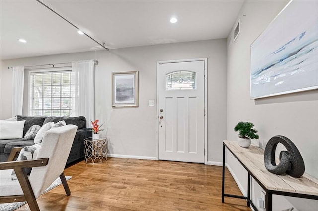 entryway with recessed lighting, baseboards, visible vents, and light wood finished floors