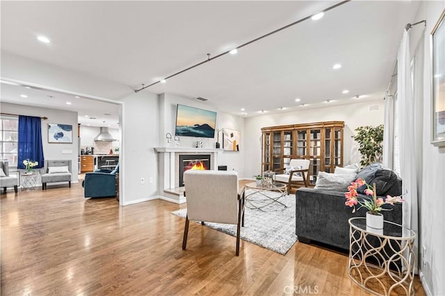 431 Preciado St, Pomona, CA 91768 - living area with a glass covered fireplace, visible vents, recessed lighting, and wood finished floors